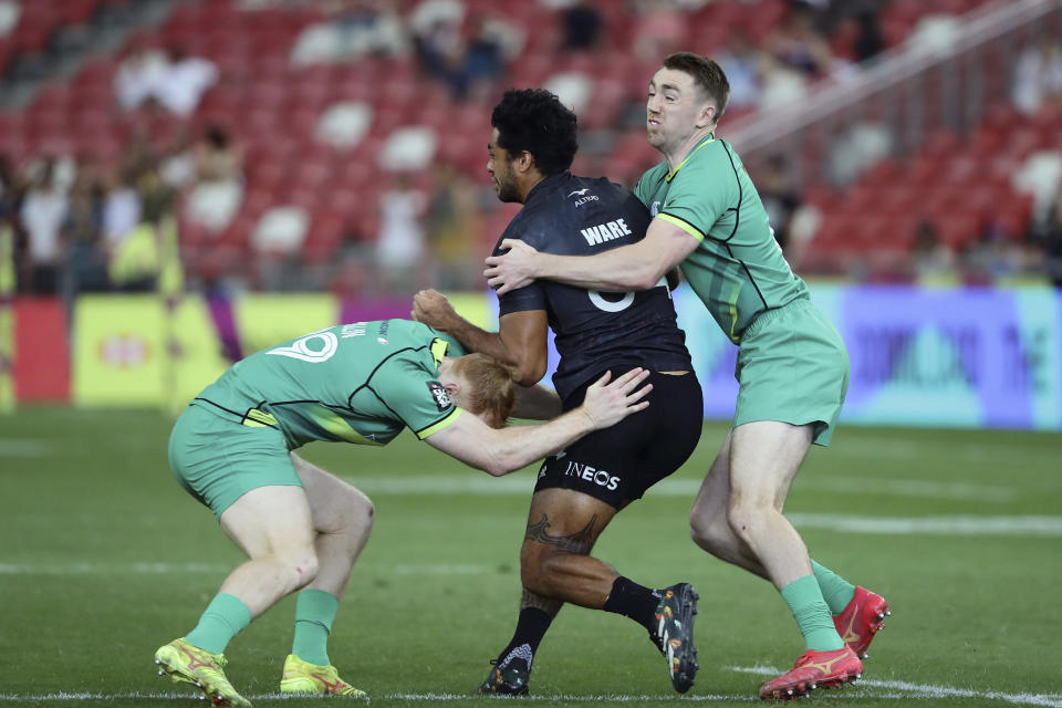 Terry Kennedy of Ireland tackles Regan Ware of New Zealand, during the men's World Rugby Sevens Series 2024 cup final between Ireland and New Zealand in Singapore, on Sunday, May 5, 2024. (AP Photo/Suhaimi Abdullah)