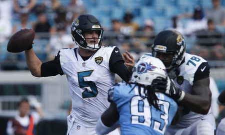 Sep 17, 2017; Jacksonville, FL, USA; Jacksonville Jaguars quarterback Blake Bortles (5) drops to throw as offensive tackle Jermey Parnell (78) blocks Tennessee Titans outside linebacker Erik Walden (93) during the second half of a football game at EverBank Field. Reinhold Matay-USA TODAY Sports