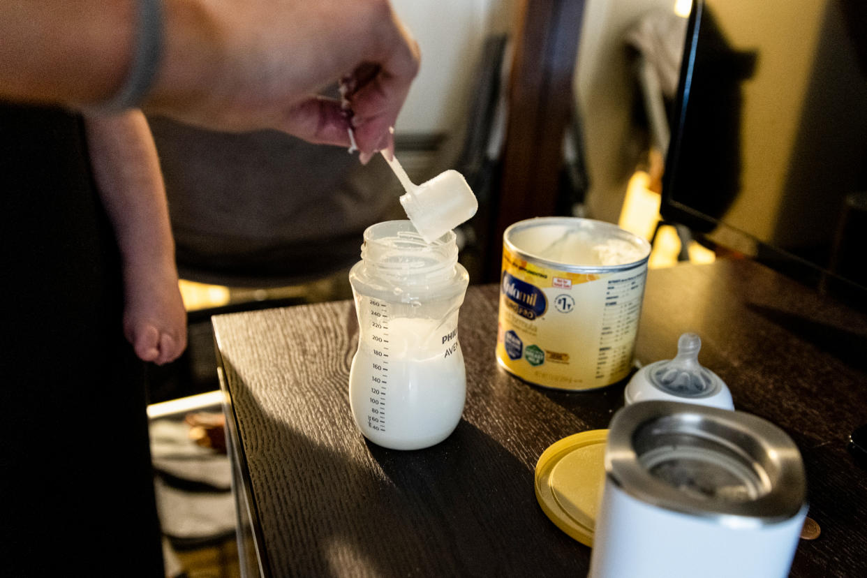 Lisa Davis mixes a bottle of formula for her 14-month old son Jack at a hotel room in Austin. (Ilana Panich-Linsman for NBC News)