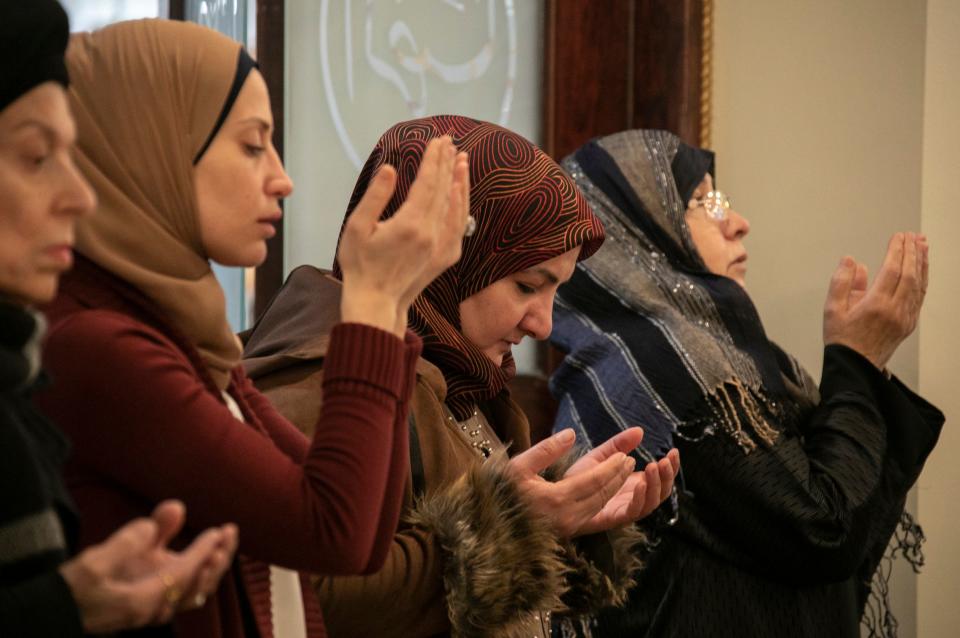 Women pray as Imam Mohammad Ali Elahi addresses the mass shooting at two mosques in New Zealand during prayers at The Islamic House of Wisdom in Dearborn Heights on Friday, March 15, 2019.