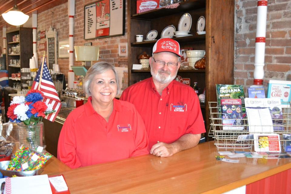 Martinsville Candy Kitchen owners Pam and John Badger pose for a photo inside the store.
