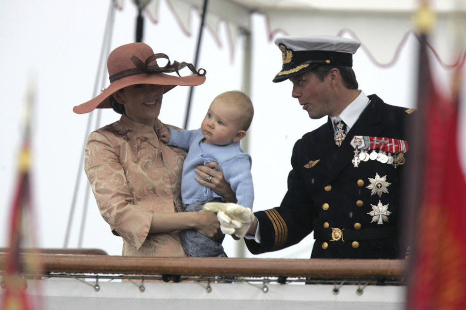 FILE - Danish Crown Princess Mary, left Crown Prince Frederik and their son, Prince Christian, wave to the crowd at Ronne, Denmark at their arrival on board the royal danish vessel Dannebrog, Wednesday, June 21, 2006. As a teenager, Crown Prince Frederik felt uncomfortable being in the spotlight, and pondered whether there was any way he could avoid becoming king. All doubts have been swept aside as the 55-year-old takes over the crown on Sunday, Jan. 14, 2024 from his mother, Queen Margrethe II, who is breaking with centuries of Danish royal tradition and retiring after a 52-year reign. (Kim Agersten/Ritzau Scanpix via AP, File)
