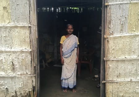 Madhubala Mandal poses for a photograph inside her bamboo hut in Bishnupur village