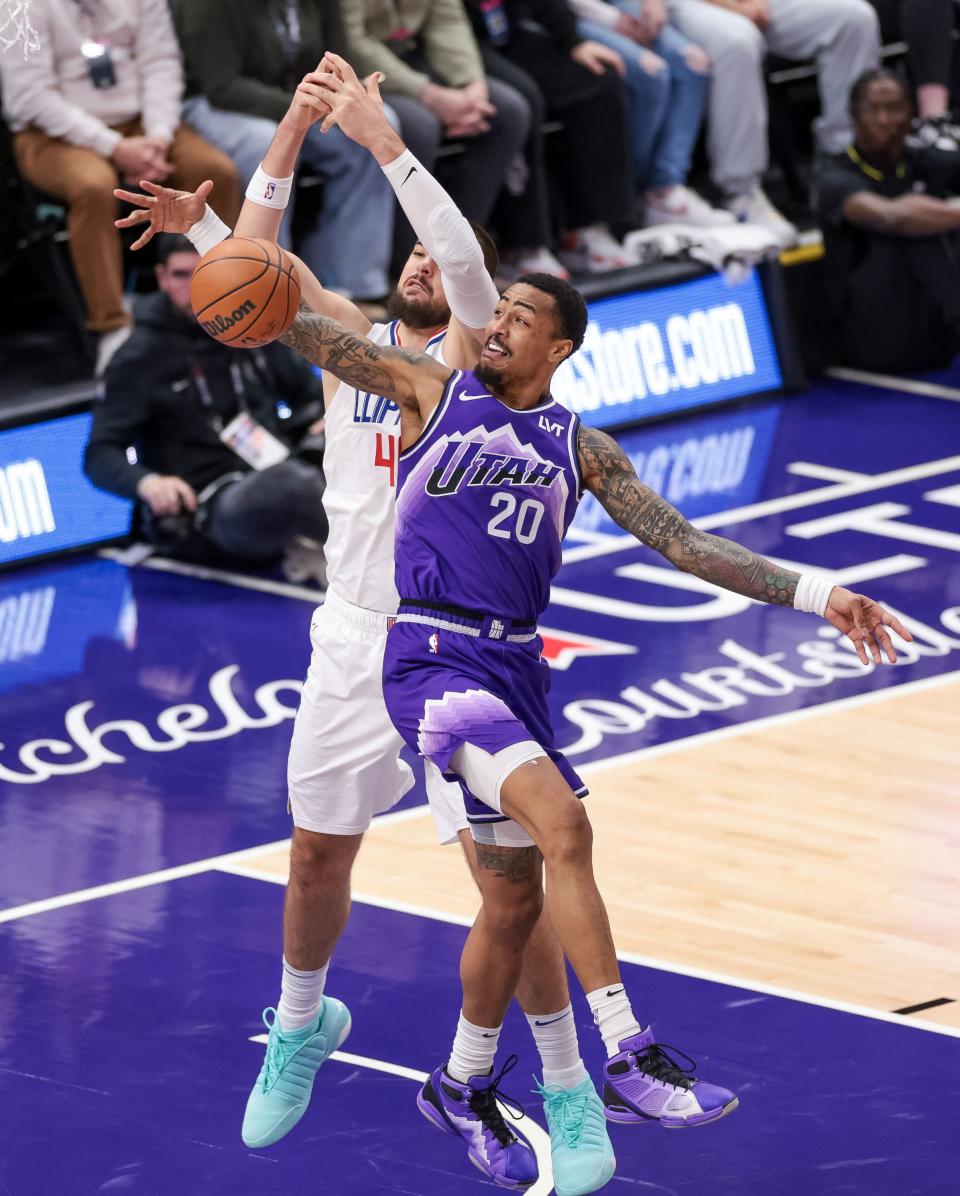 Utah Jazz forward John Collins (20) steals a long pass to LA Clippers center Ivica Zubac (40) at the Delta Center in Salt Lake City on Friday, Dec. 8, 2023. | Spenser Heaps, Deseret News