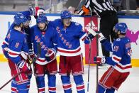 New York Rangers' Ryan Lindgren (55) celebrates an empty net goal with teammates Jacob Trouba (8), Kevin Rooney (17), Andrew Copp (18) and Mika Zibanejad during the third period of Game 5 of an NHL hockey Stanley Cup first-round playoff series against the Pittsburgh Penguins Wednesday, May 11, 2022, in New York. The Rangers won 5-3. (AP Photo/Frank Franklin II)