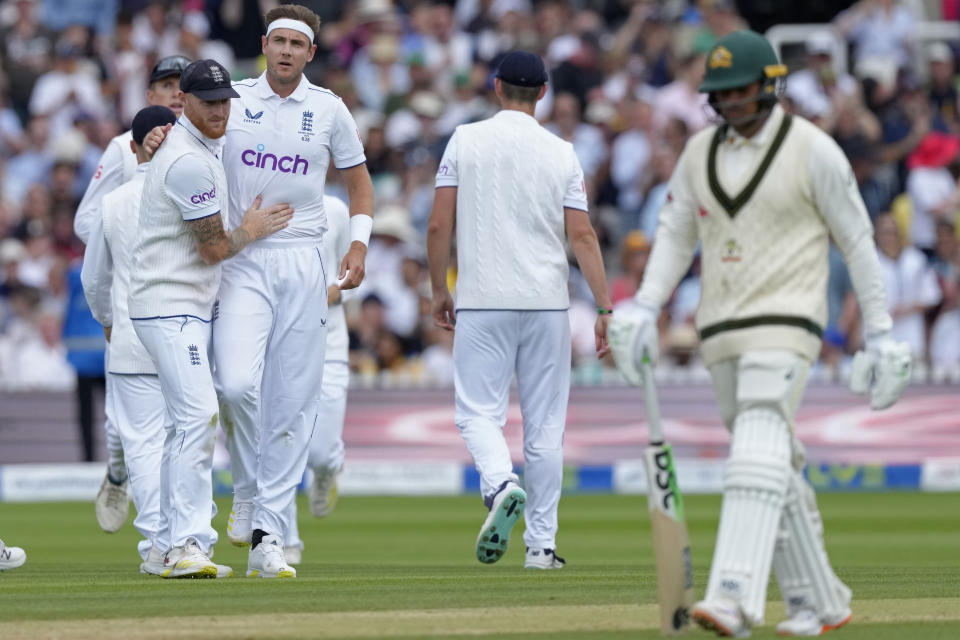 England's captain Ben Stokes, left, hugs teammate Stuart Broad to congratulate him on dismissing Australia's Usman Khawaja, right, during the fourth day of the second Ashes Test match between England and Australia, at Lord's cricket ground in London, Saturday, July 1, 2023. (AP Photo/Kirsty Wigglesworth)