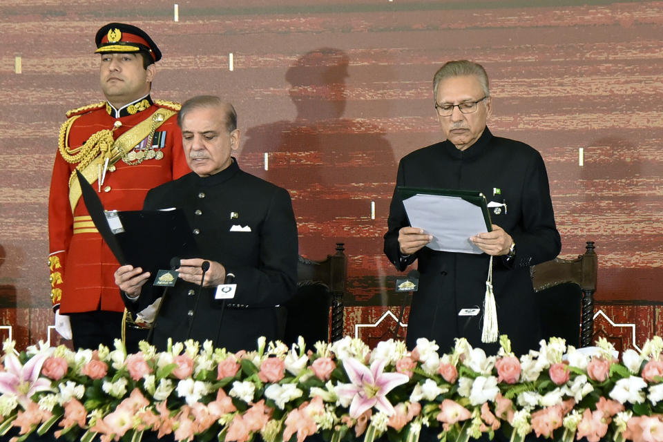 In this photo released by the Pakistan's President Office, President Arif Alvi, right, administers the oath of office to newly elected Prime Minister Shehbaz Sharif during a ceremony at the Presidential Palace, in Islamabad, Pakistan, Monday, March 4, 2024. Lawmakers in Pakistan's National Assembly have elected Sharif for a comeback term as the country's prime minister, as allies of imprisoned former premier Imran Khan in parliament shouted in protest, alleging rigging in last month's election. (Pakistan's President Office via AP)