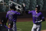 Colorado Rockies' Trevor Story (27) gets a high-five from Charlie Blackmon after Story hit a home run during the third inning of a spring training baseball game against the Arizona Diamondbacks Tuesday, March 9, 2021, in Scottsdale, Ariz. (AP Photo/Ashley Landis)