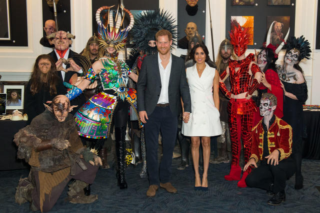 The Duke and Duchess of Sussex pose for a photo with actors in costume during a visit to Courtenay Creative, in Wellington (PA)