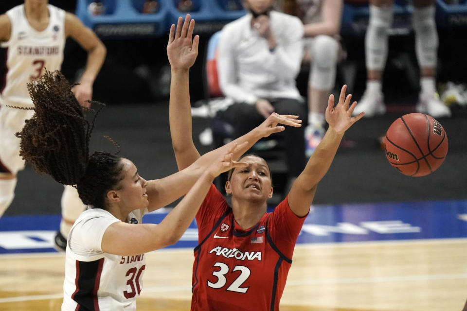 Stanford guard Haley Jones (30) passes over Arizona forward Lauren Ware (32) during the second half of the championship game in the women's Final Four NCAA college basketball tournament, Sunday, April 4, 2021, at the Alamodome in San Antonio. (AP Photo/Morry Gash)