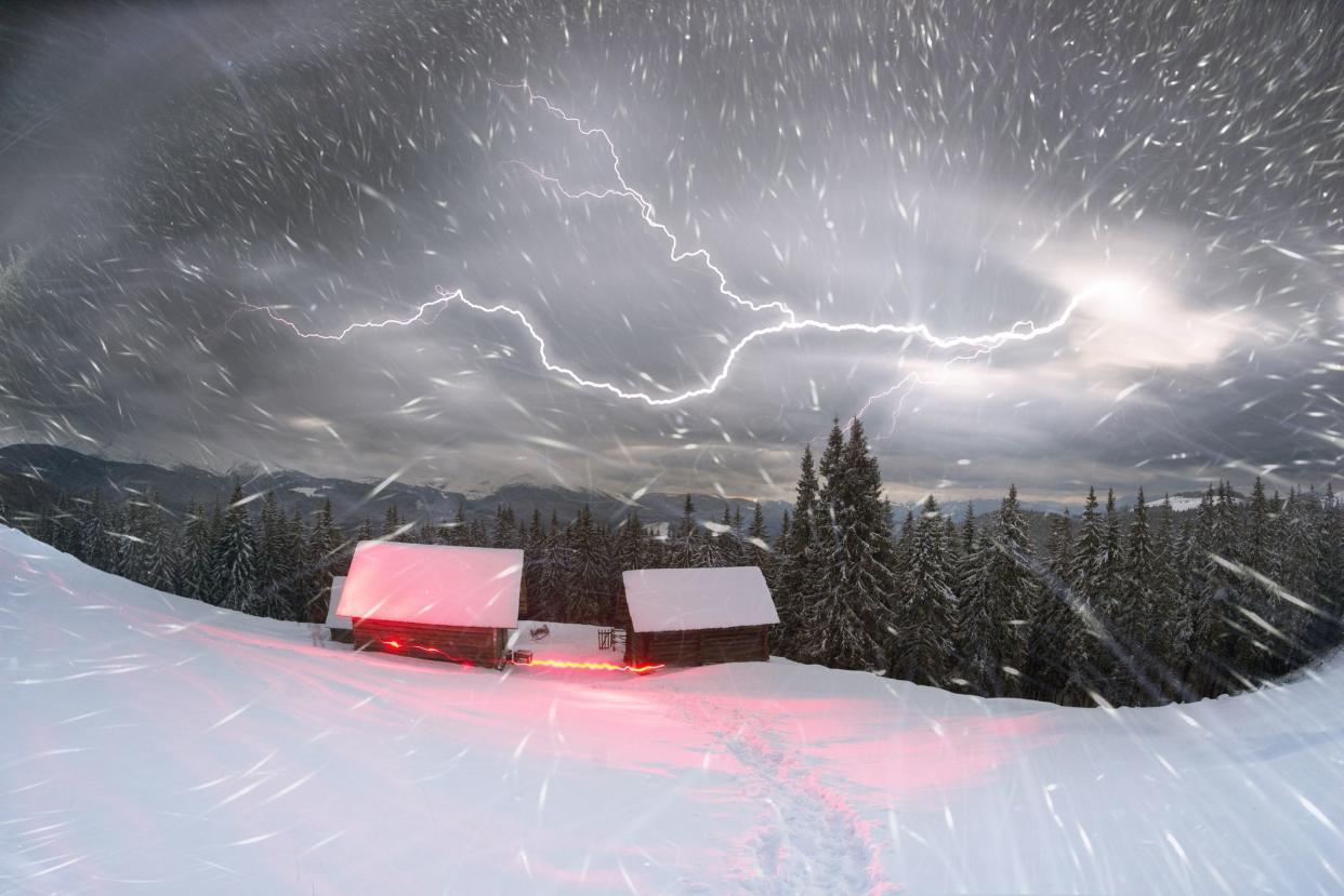 Houses of shepherds in the Carpathians, Ukraine, a tourist trek in winter gives special extreme sensations of nature on top against the backdrop high ridge of Chernogory from Goverla