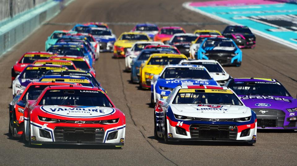 Kyle Larson (5) and William Byron (24) lead the restart during the NASCAR Cup Series playoff race at Homestead-Miami Speedway on Oct. 23, 2022.