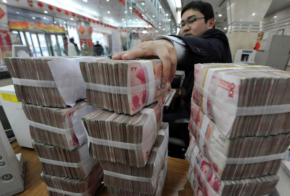 An employee counts Chinese yuan banknotes at a Bank of China branch in Hefei, Anhui province March 10, 2010. — Reuters pic