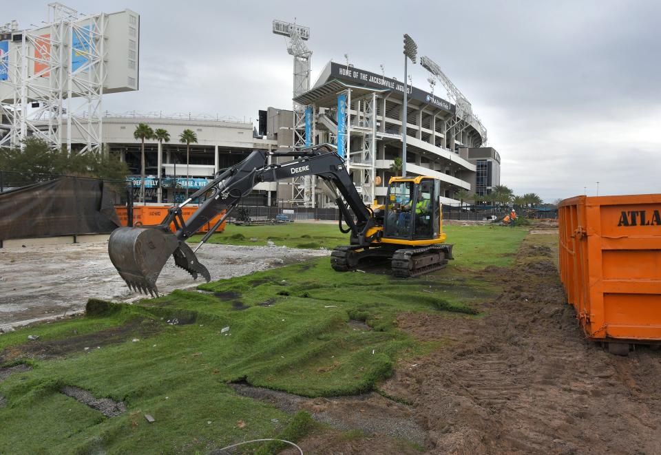 Astroturf and scraps of the bleachers on the Jaguars' old practice field are removed in January during the construction of the team's new sports performance facility.