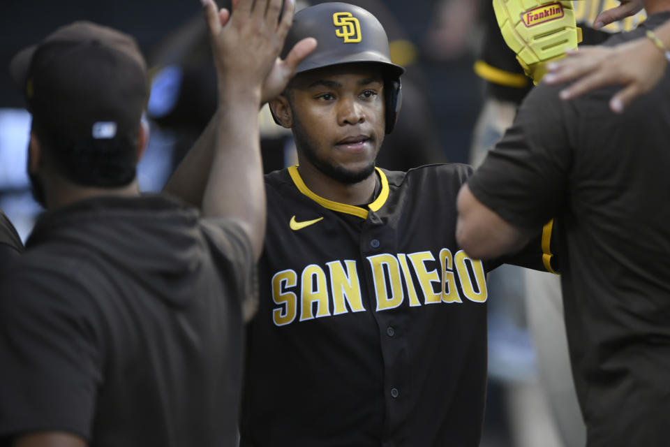 San Diego Padres' Jose Azocar celebrates with teammates in the dugout after scoring on a Jurickson Profar single during the 11th inning of a baseball game against the Chicago White Sox, Sunday, Oct. 1, 2023, in Chicago. (AP Photo/Paul Beaty)