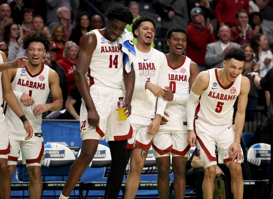 Alabama players on the bench celebrate near the end of the second half of the team's NCAA men's tournament game against Maryland at Legacy Arena.