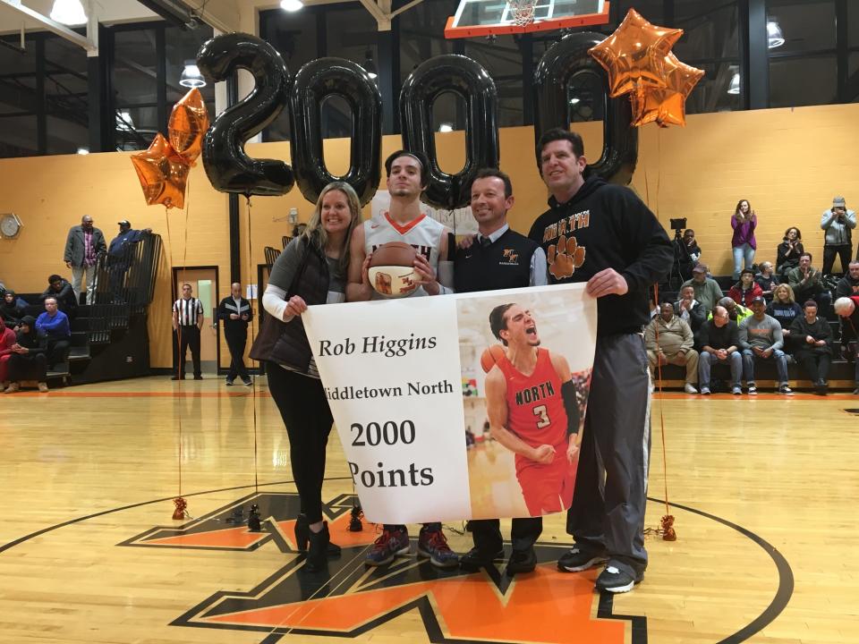 With his parents on the end, his coach (Mike Iasparro) in the center, Middletown North's Rob Higgins (2nd from the left) celebrates his career milestone (2,000 career points) on Jan. 24, 2019 at Middletown North High School in a 66-63 loss to Neptune.