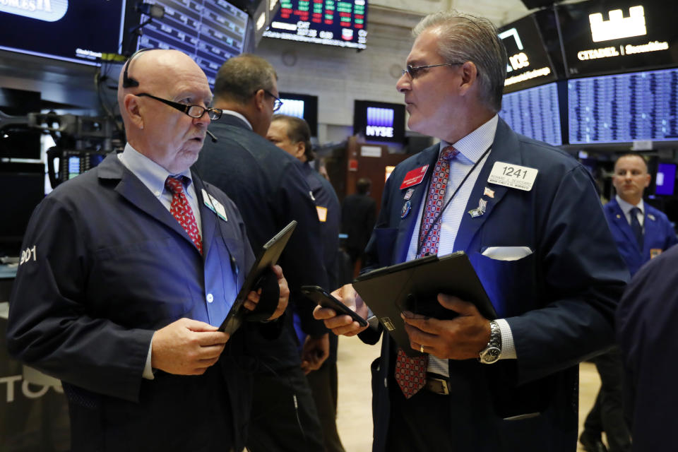 Traders John Doyle, left, and Richard Deviccaro work on the floor of the New York Stock Exchange, Wednesday, Sept. 4, 2019. Stocks are opening higher on Wall Street following big gains in Asia as Hong Kong's government withdrew a controversial extradition law that set off three months of protests there. (AP Photo/Richard Drew)