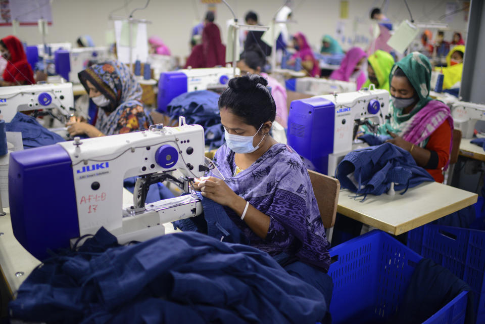 Garment employees work at Arrival Fashion Limited in Gazipur, Bangladesh, Saturday, March 13, 2021. On the eve of a half-century of independence this week, Bangladesh has been hailed as a success story for a young nation born out of strife and turbulence. Although it has struggled with famine, poverty, military coups and political violence, it's also been celebrated for what experts say is remarkable progress in uplifting the lives of its young population. Millions have risen out of poverty as the country has unexpectedly become one of Asia’s fastest-growing economies thanks to sectors like its garment industry, which clothes millions around the world. (AP Photo/Mahmud Hossain Opu)