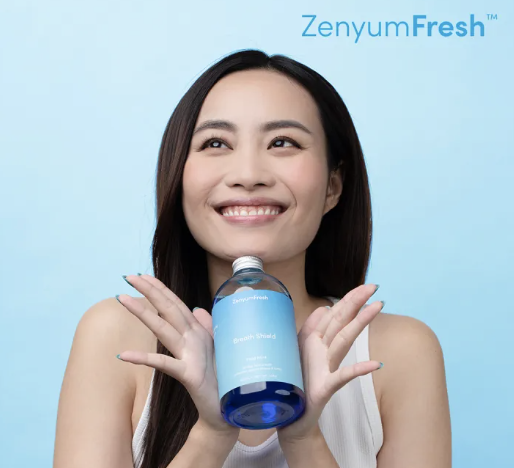 lady holding to mouthwash and smiling