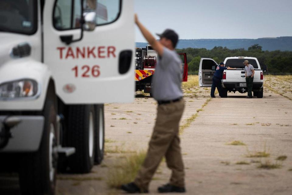 Fire department crews are on standby at the staging area for the Dempsey Fire on Monday, June 27, 2022 near Palo Pinto.