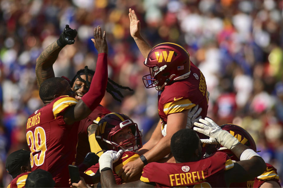 Washington Commanders place kicker Austin Seibert, top right, celebrates with teammate after kicking the game-winning field goal against the New York Giants during the second half of an NFL football game in Landover, Md., Sunday, Sept. 15, 2024. (AP Photo/Steve Ruark)