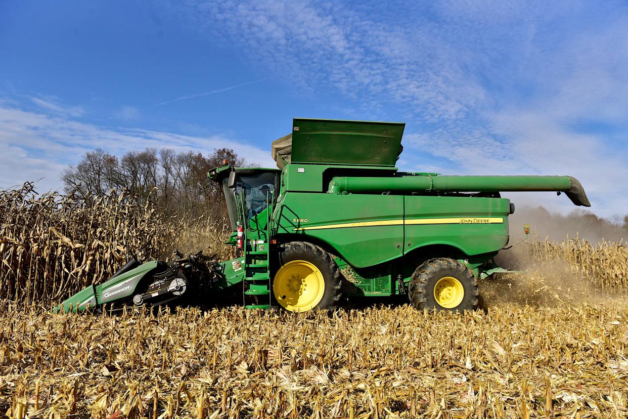 George Noggle uses a combine harvester to pick corn for Zoe Kent in Crawford County.