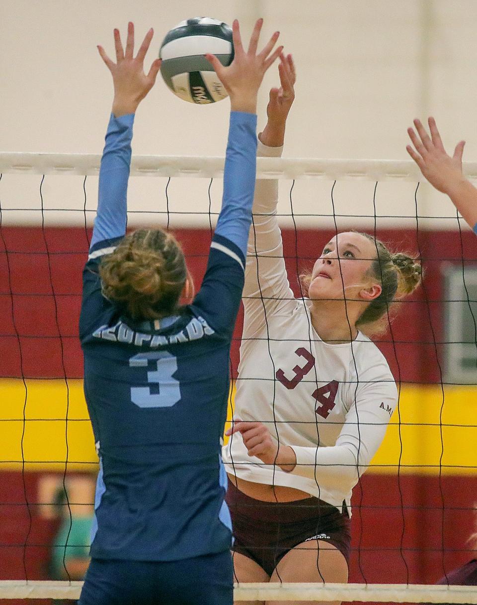 Walsh Jesuit's Taylor Angielski spikes the ball past Louisville's Taylor McCully in a Division I sectional tournament on Wednesday, Oct. 19, 2022 in Cuyahoga Falls, Ohio, at Walsh Jesuit High School.