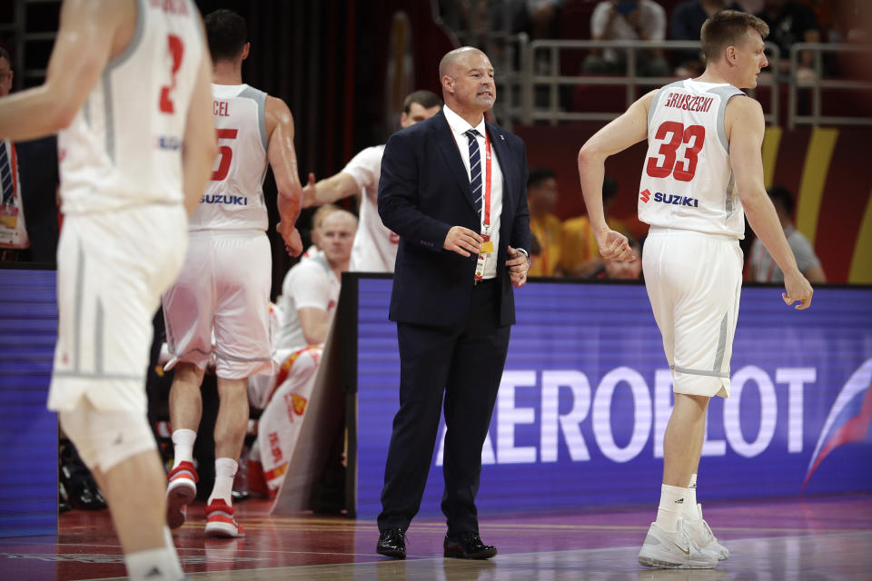 In this Saturday, Aug. 31, 2019 photo, Poland's head coach Mike Taylor talks to his team during their group phase basketball game against Venezuela in the FIBA Basketball World Cup at the Cadillac Arena in Beijing. American coach Mike Taylor led Poland to its first World Cup victory in 52 years in the first game against Venezuela. Now he'll try to upset host China in the second game on Monday. (AP Photo/Mark Schiefelbein)