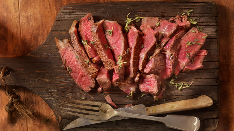 sliced rare steak with steak knife