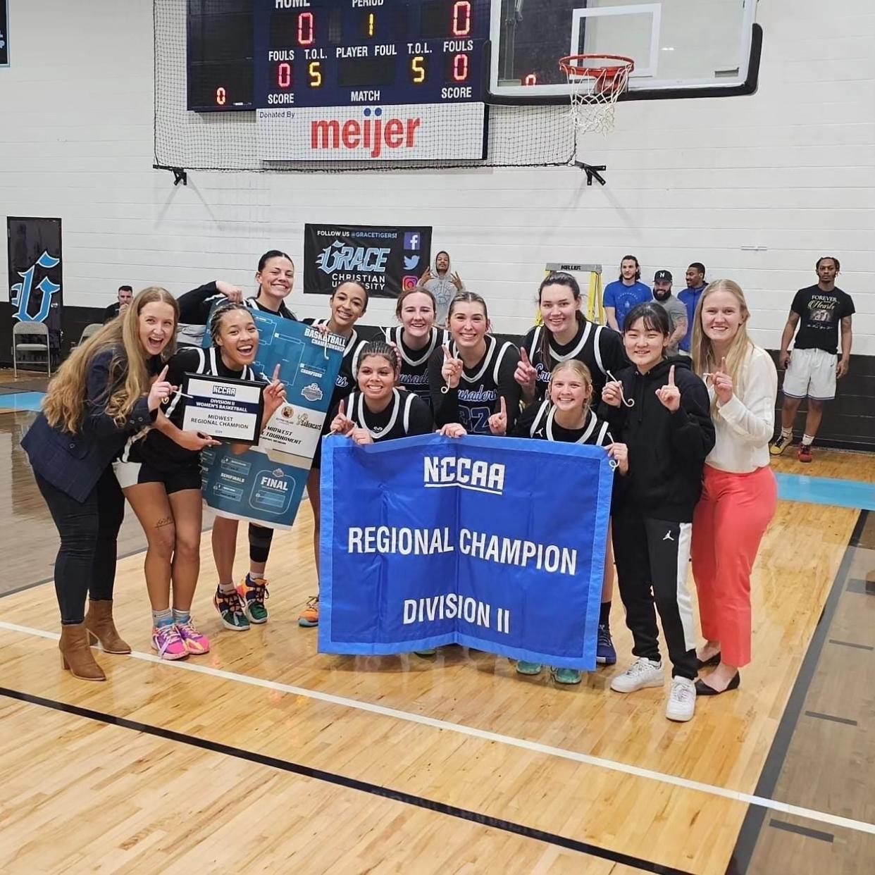 Great Lakes Christian College's women's basketball team celebrates its regional championship earlier this month.