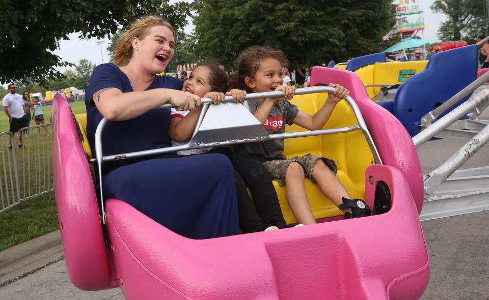 Taylor Stanley, daughter Mya Rose, 4, and niece London Carr ride the Sizzler on July 16. The music, food and rides hit sweet spots for visitors.