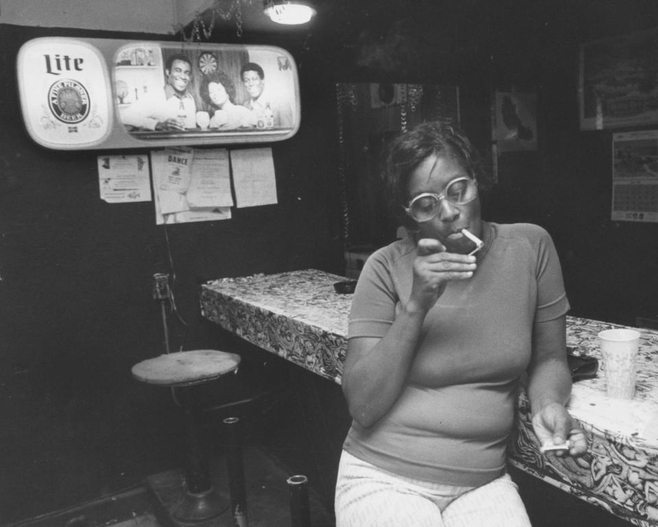 Shirley Maxwell, of 3003 Greenwood Ave., lit a cigarette Thursday at the Screaming Eagle bar. Aug. 5, 1981