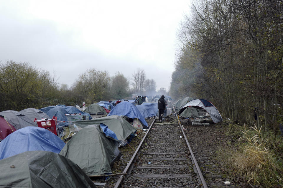 FILE - A makeshift camp with migrants is set up along a rail in Calais, northern France, on Nov. 27, 2021. At a summit on Feb. 9-10, 2023, the EU's 27 heads of state and government are set to emphasise the importance of beefing up borders and pressuring the often-impoverished countries that people leave or cross to get to Europe, according to a draft statement prepared for the meeting. (AP Photo/Rafael Yaghobzadeh, File)