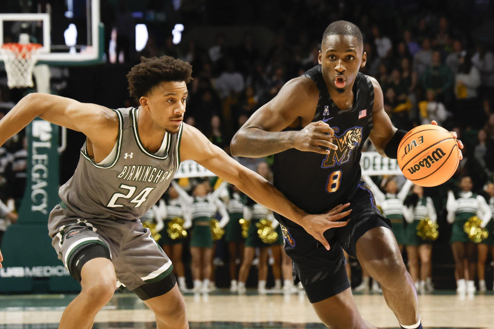 Memphis forward David Jones (8) drives past UAB guard Efrem Johnson (24) as he goes to the basket during the first half of an NCAA college basketball game, Sunday, Jan. 28, 2024, in Birmingham, Ala. (AP Photo/Butch Dill)