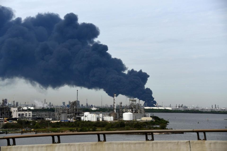 PHOTO: A fire at a Intercontinental Terminals Company tank farm in Deer Park spews smoke and benzene from a  chemical storage site that erupted a day earlier, March 18, 2019, from Texas Highway 146 in La Porte, Texas. (Paul Harris/Getty Images, FILE)
