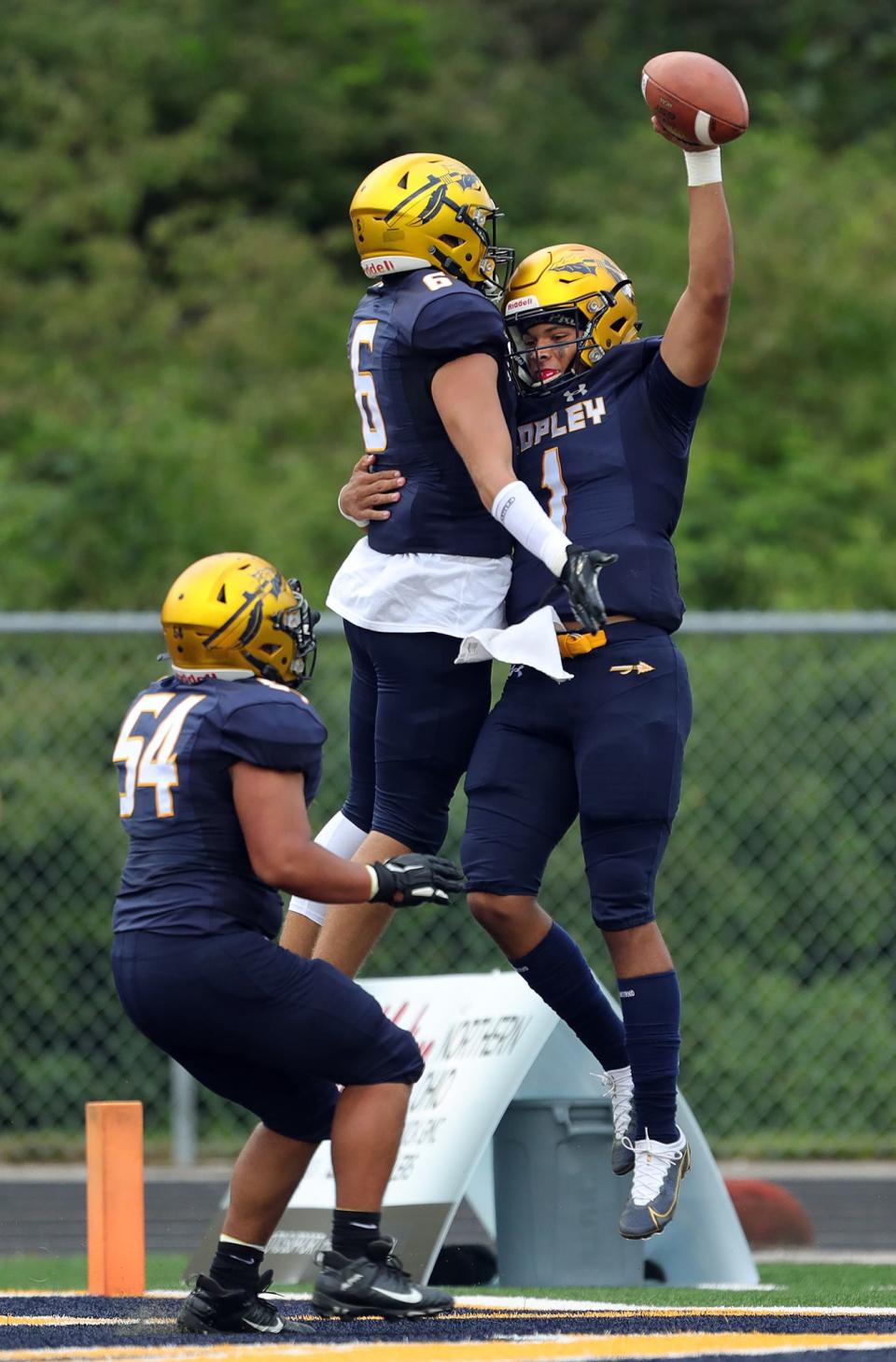 Copley quarterback DaOne Owens, right, celebrates in the end zone with wide receiver Trent Wininger after scoring a rushing touchdown against Firestone during the first half of a high school football game, Friday, Aug. 26, 2022, in Copley, Ohio.