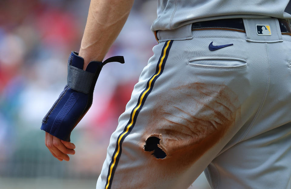 ATLANTA, GEORGIA - JULY 30:  Christian Yelich #22 of the Milwaukee Brewers reacts after tearing a hole in his pants on a slide while advancing to third base on a single by William Contreras #24 in the first inning against the Atlanta Braves at Truist Park on July 30, 2023 in Atlanta, Georgia. (Photo by Kevin C. Cox/Getty Images)