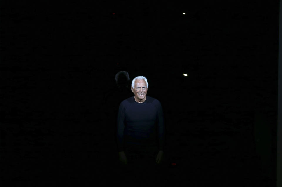 Italian fashion designer Giorgio Armani ackowledges applause at the end of his Emporio Armani men's Fall-Winter 2014 collection, part of the Milan Fashion Week, unveiled in Milan, Italy, Monday, Jan. 13, 2014. (AP Photo/Antonio Calanni)