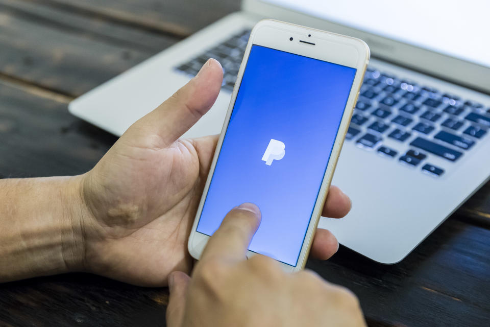 HONG KONG, HONG KONG - JULY 13:A man holds a smart phone with PayPal application is displayed on July 13 2018 in Hong Kong, Hong Kong. (Photo by S3studio/Getty Images)