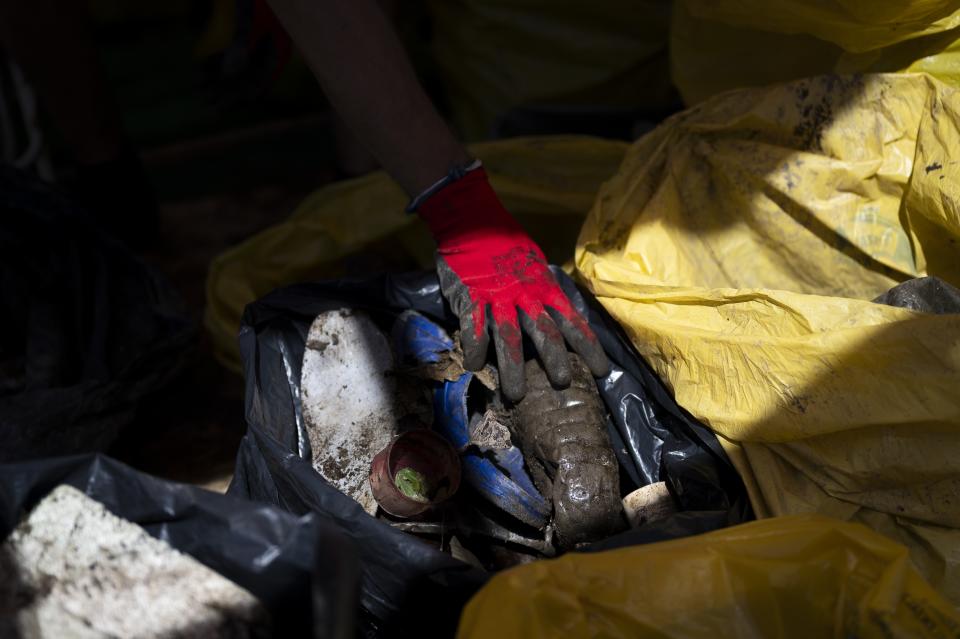 FILE - Volunteers sort the collected rubbish on their boat while attending the Plastic Cup event near Tiszaroff, Hungary, Aug. 2, 2023. (AP Photo/Denes Erdos, File)