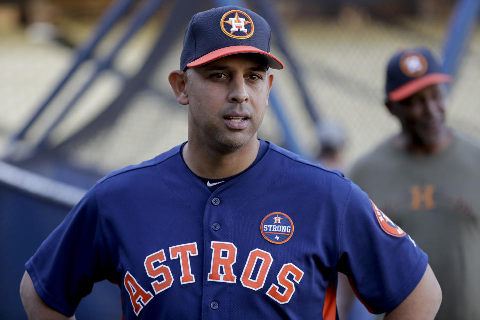 FILE - In this Oct. 23, 2017, file photo, Houston Astros bench coach Alex Cora watches batting practice during media day for baseball's World Series against the Los Angeles Dodgers, in Los Angeles. Houston manager AJ Hinch and general manager Jeff Luhnow were suspended for the entire season Monday, Jan. 13, 2020, and the team was fined $5 million for sign-stealing by the team in 2017 and 2018 season. Commissioner Rob Manfred announced the discipline and strongly hinted that current Boston manager Alex Cora — the Astros bench coach in 2017 — will face punishment later. Manfred said Cora developed the sign-stealing system used by the Astros. (AP Photo/David J. Phillip, File)