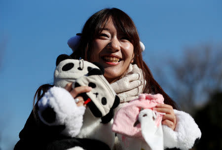 Panda enthusiast Saeko Nishitani, 23, poses for a photograph after the public viewing of female baby panda Xiang Xiang, born from mother panda Shin Shin on June 12, 2017, on the first day of her public debut at Ueno Zoological Gardens in Tokyo, Japan December 19, 2017. REUTERS/Issei Kato