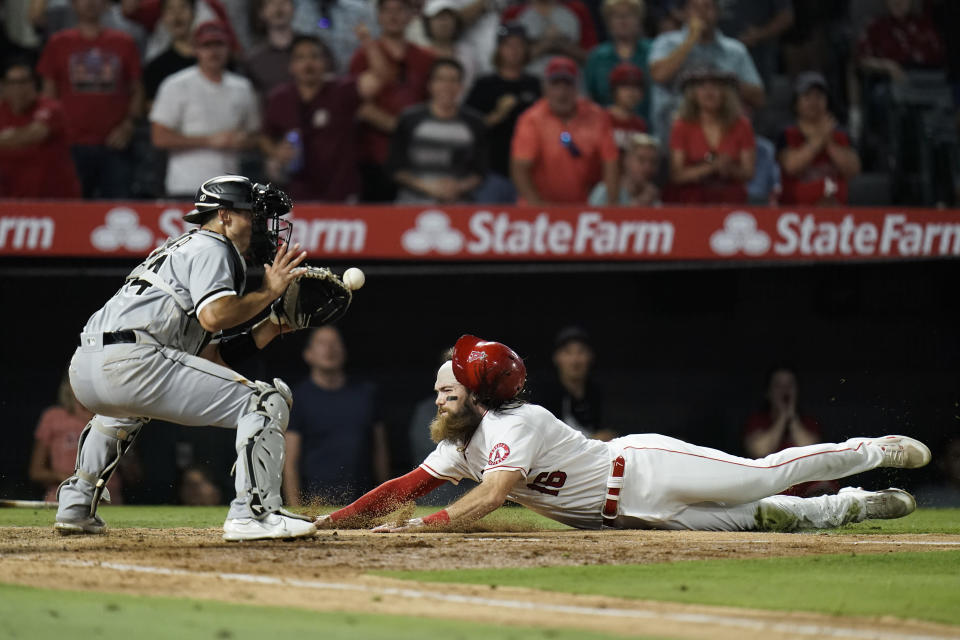 Los Angeles Angels' Brandon Marsh, right, slides into home plate against Chicago White Sox catcher Seby Zavala to score on a double by Taylor Ward during the seventh inning of a baseball game Monday, June 27, 2022, in Anaheim, Calif. (AP Photo/Jae C. Hong)