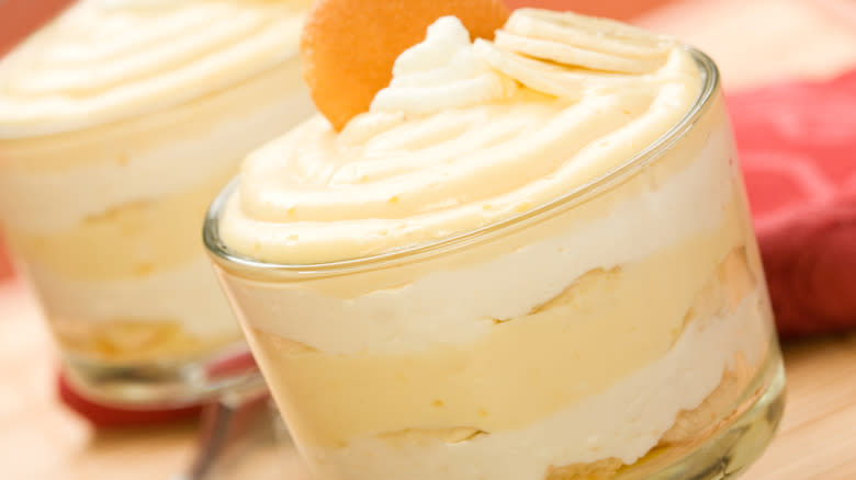 banana pudding in glass topped with sliced banana an Nilla wafer close up