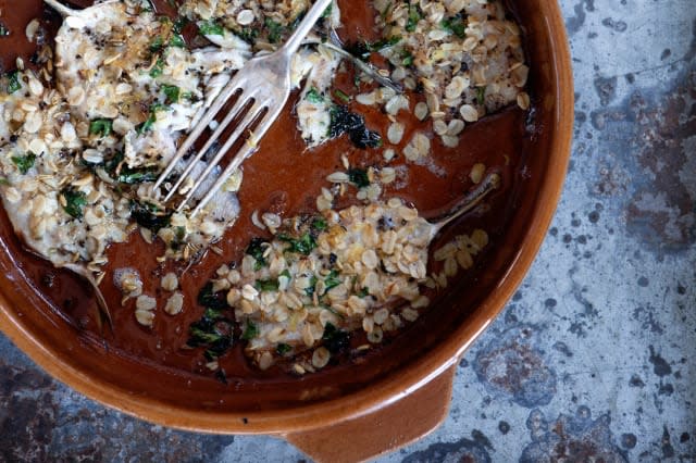 Plate of fish with oatmeal and herbs