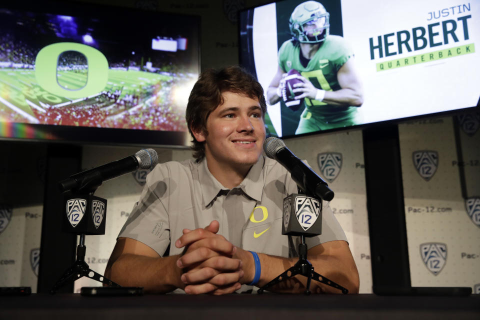 Oregon quarterback Justin Herbert answers questions during the Pac-12 Conference NCAA college football Media Day Wednesday, July 24, 2019, in Los Angeles. (AP Photo/Marcio Jose Sanchez)