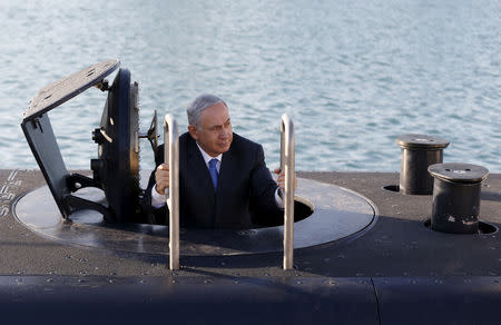 FILE PHOTO: Israeli Prime Minister Benjamin Netanyahu climbs out of a navy submarine after it arrived in Haifa port, Israel January 12, 2016. REUTERS/Baz Ratner/File Photo