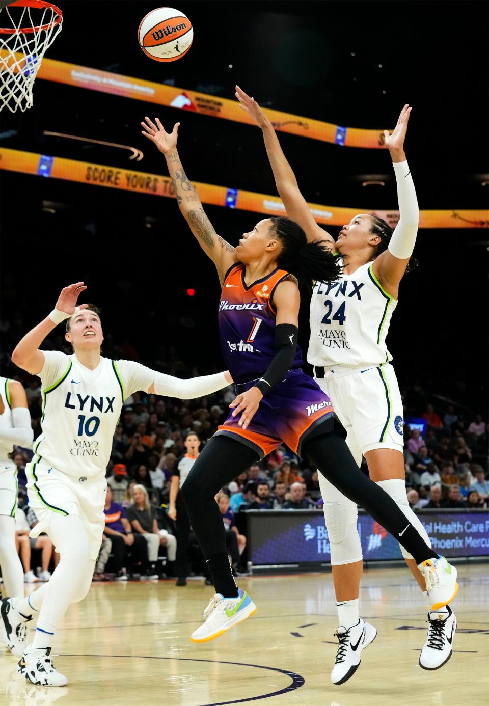 Phoenix Mercury guard Sug Sutton (1) drives to the basket against Minnesota Lynx forwards Jessica Shepard (10) and Napheesa Collier (24) at Footprint Center in Phoenix on May 25, 2023.