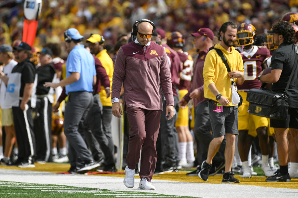 Minnesota head coach P.J. Fleck walks the sideline against Purdue in the second half of an NCAA college football game, Saturday, Oct. 1, 2022, in Minneapolis. Purdue won 20-10. (AP Photo/Craig Lassig)